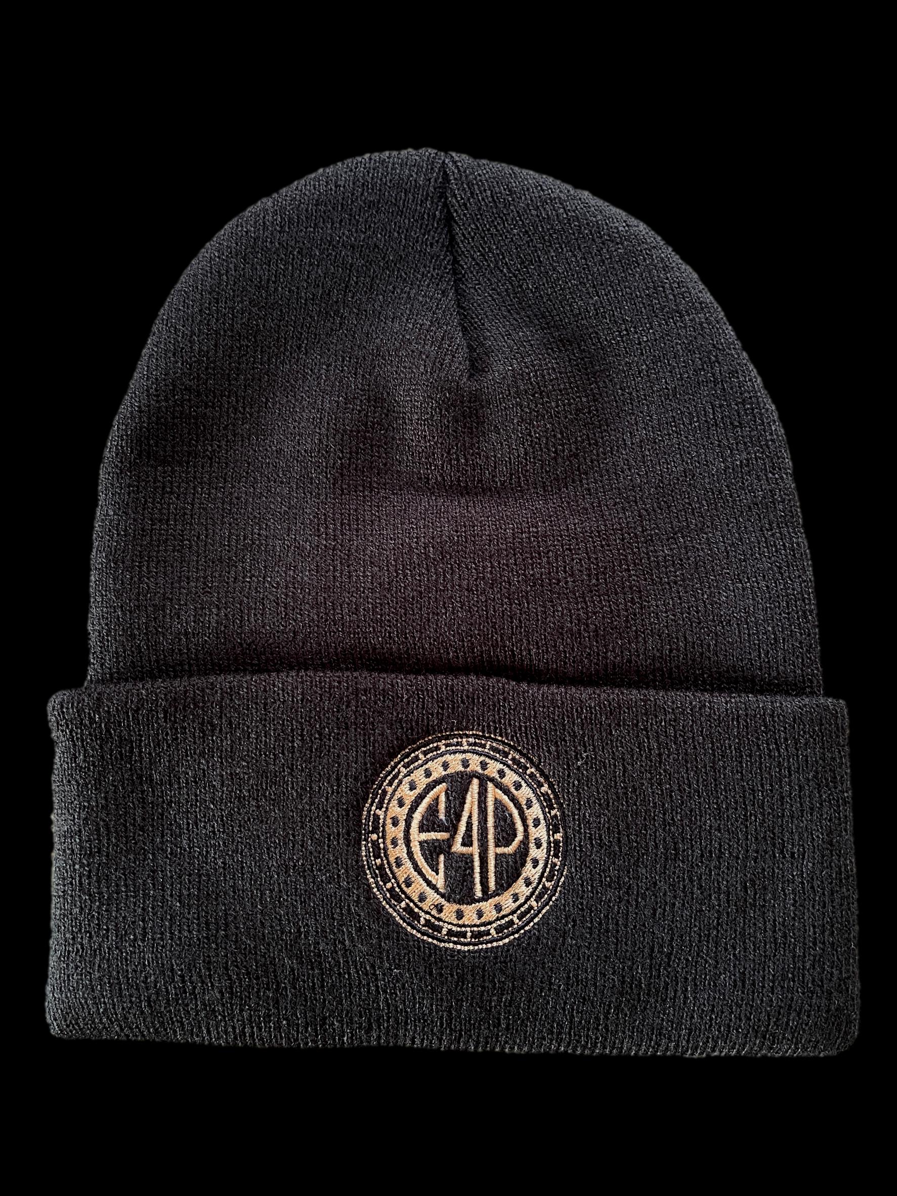 A black cuffed beanie with a textured design and a gold stamp logo on the front.