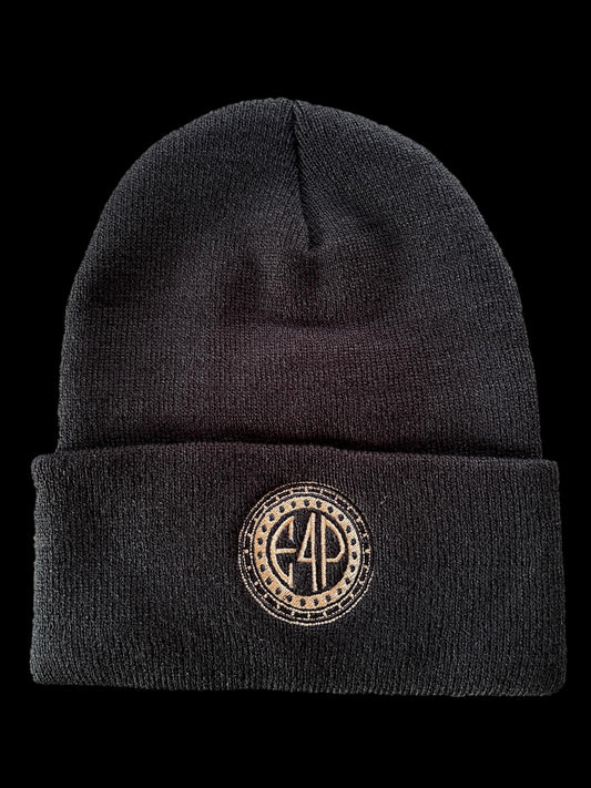 A black cuffed beanie with a textured design and a gold stamp logo on the front.